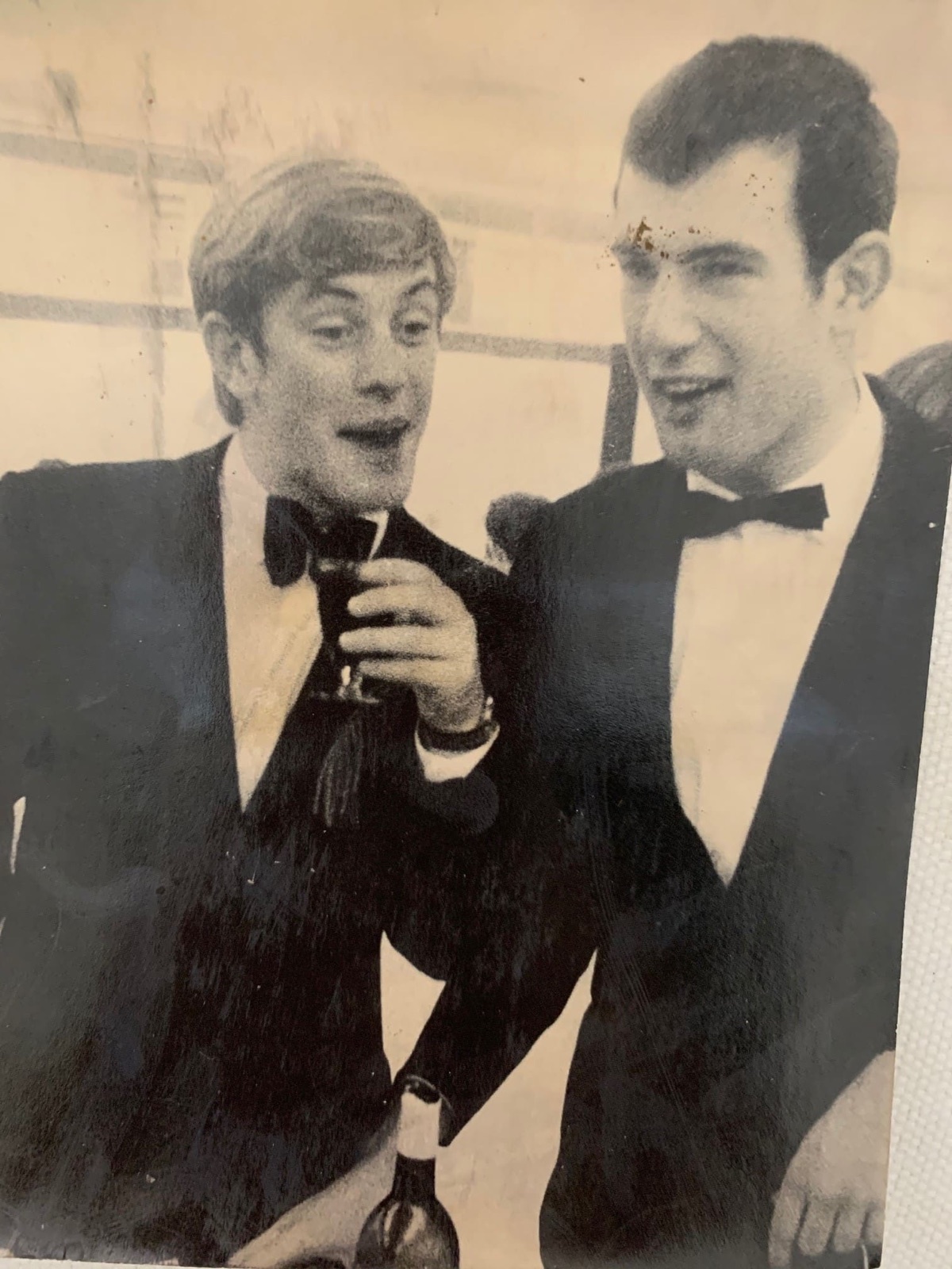 Two students in bow ties at a microphone, early years